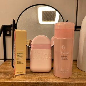 Glossier lip balm, hand cream and solution.